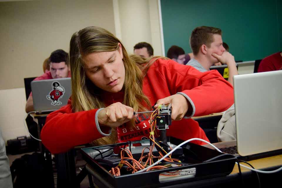 A student works with electronics in class