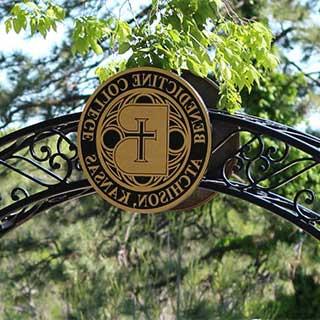 The Benedictine College Seal in an iron archway